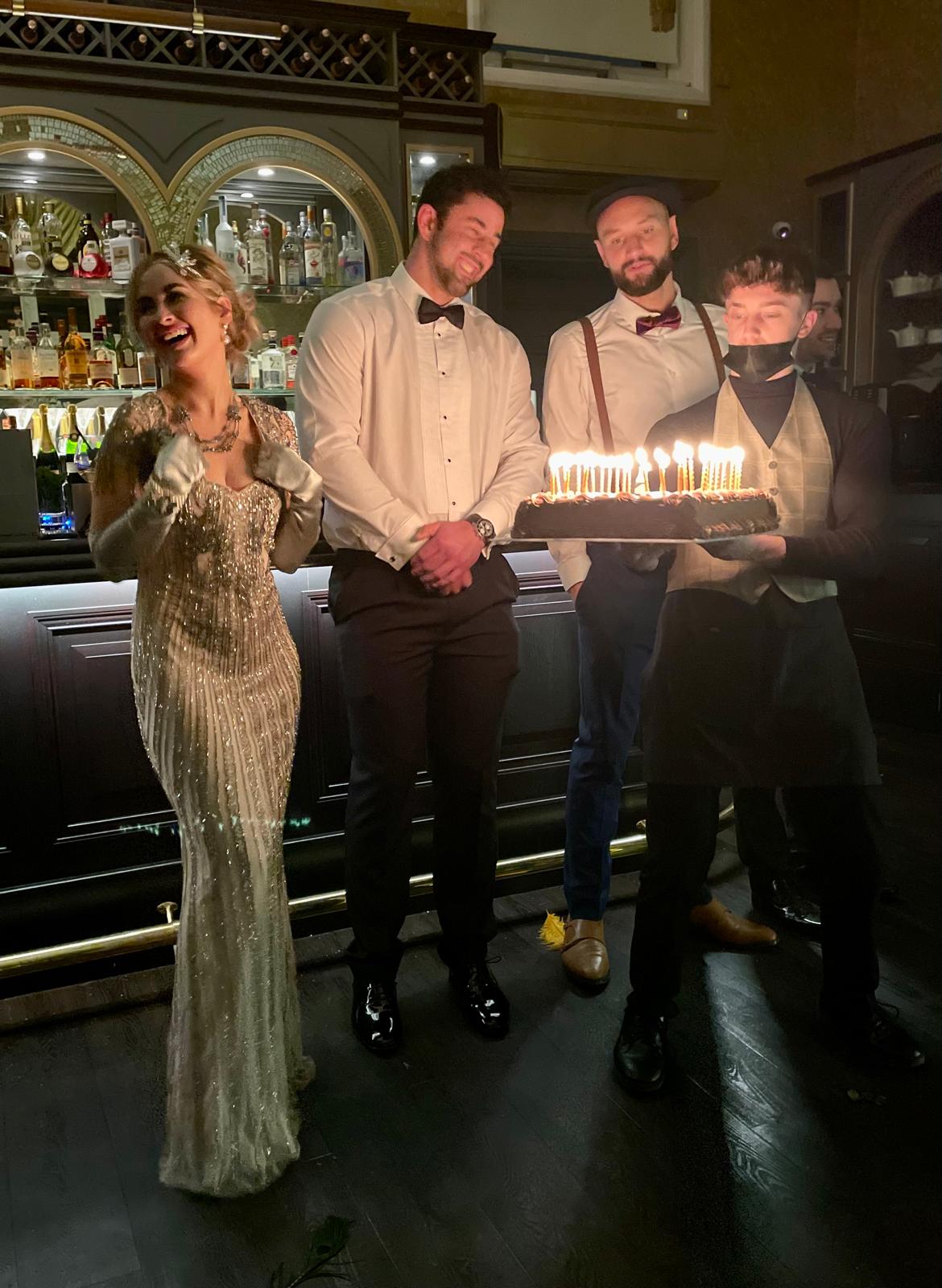 A milestone birthday cake being presented to guests at 3 St Peter's